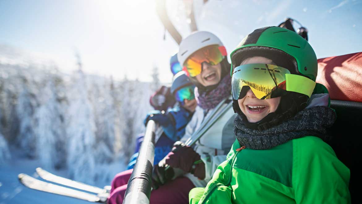 Family sitting on a ski lift