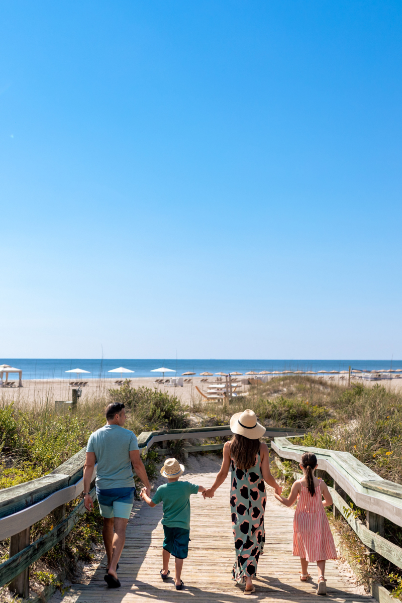 Family walking on beach boardwalk at Omni Amelia Island Resort