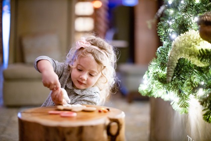 Little girl decorating gingerbread cookies