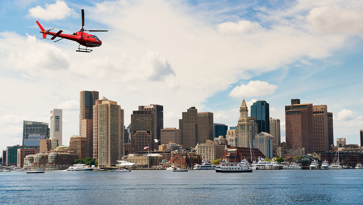 Helicopter flying over Boston skyline