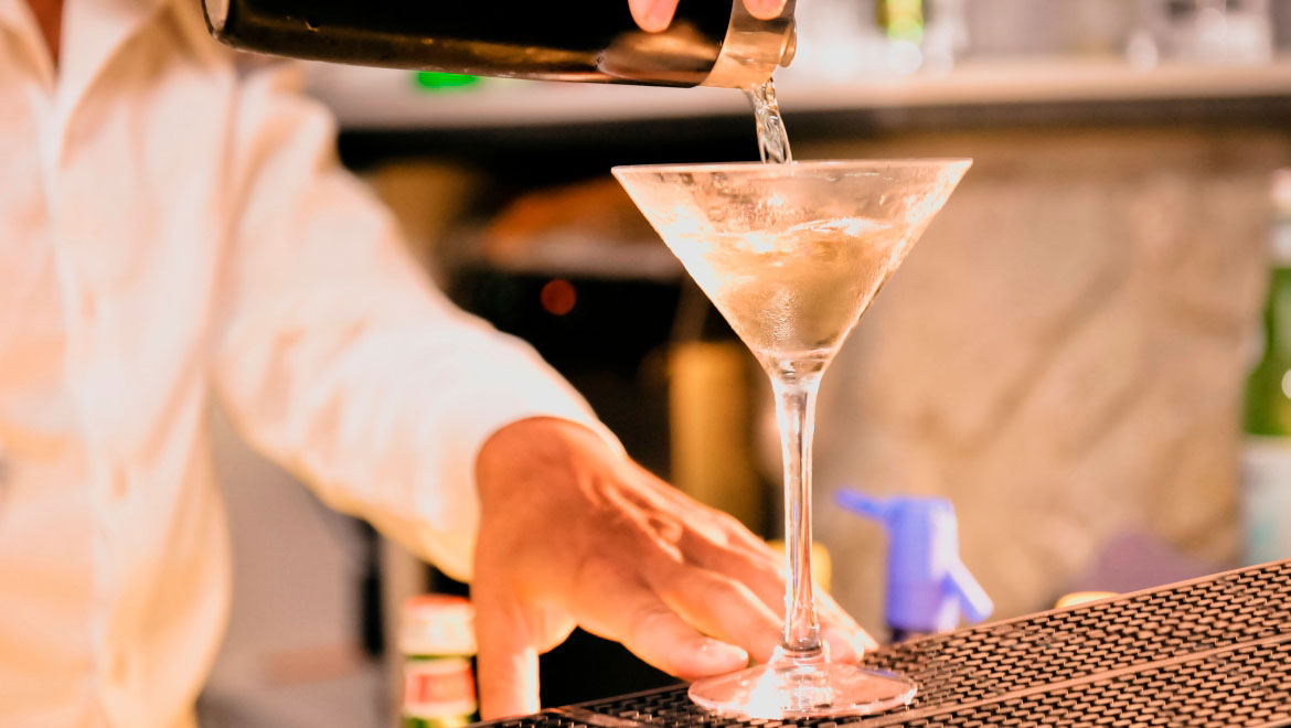 Bartender pouring martini.