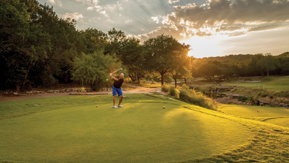 Man putting on putting green.