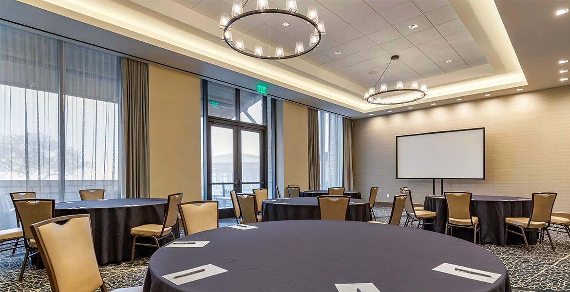 Meeting space set up with round tables.