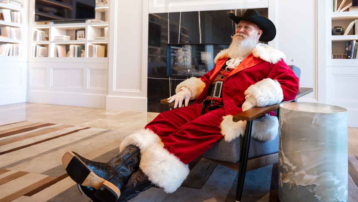 Santa reclining in a chair.