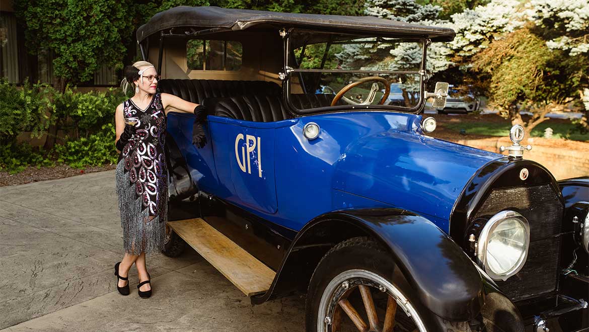 Woman posing next to retro car
