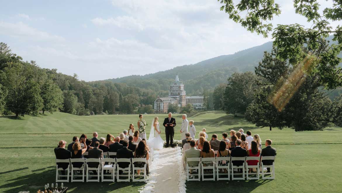 Couple getting married on the pavilion lawn at Omni Homestead Resort