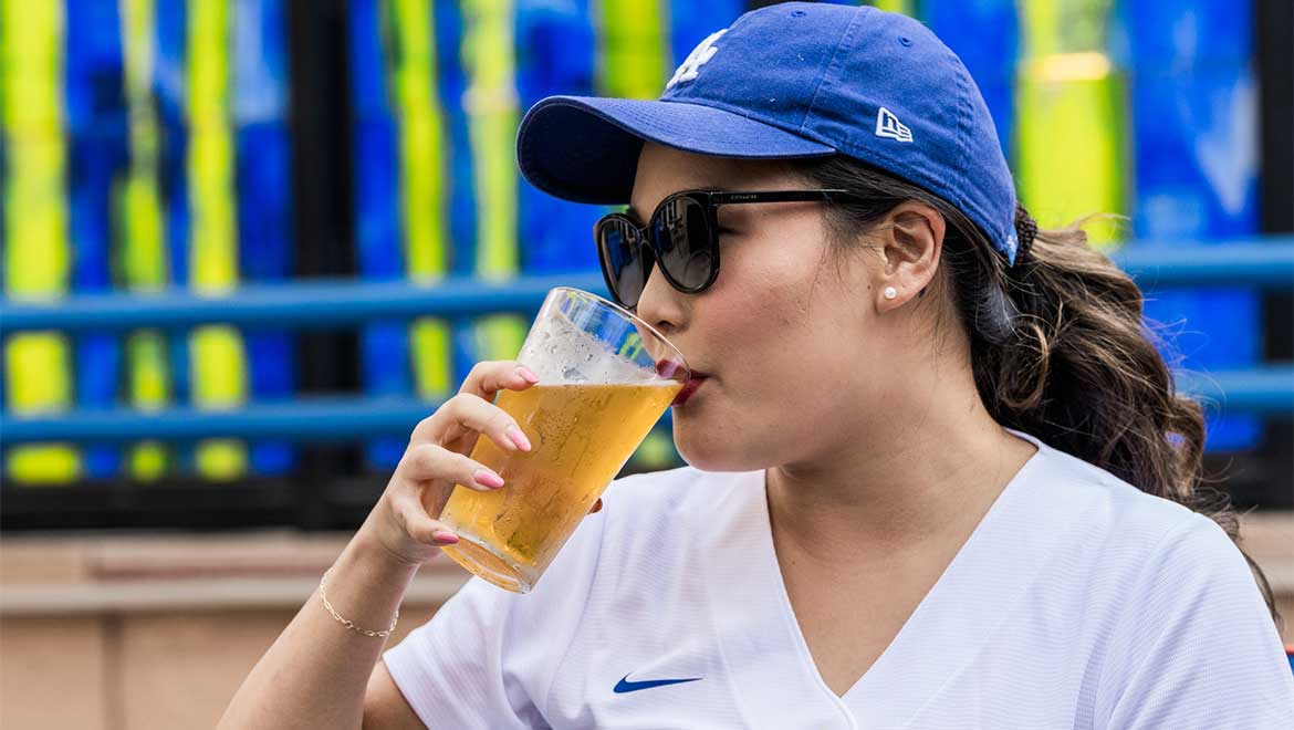 Woman sipping on a glass of beer