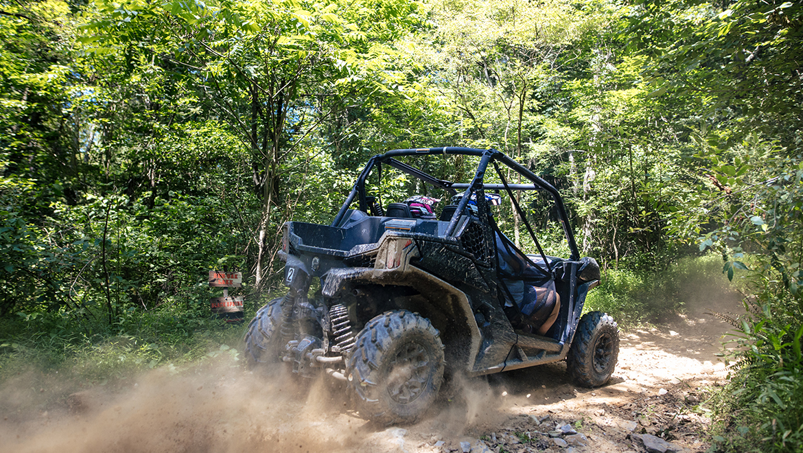 People riding in an off road vehicle.