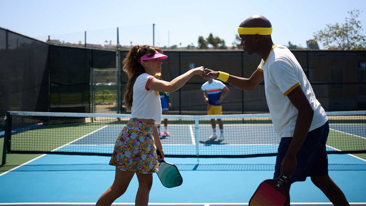 Pickleball partners fist bumping